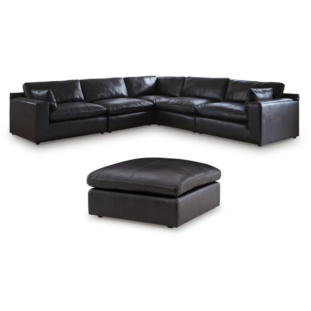 Black top-grain leather sectional sofa with chaise and matching ottoman