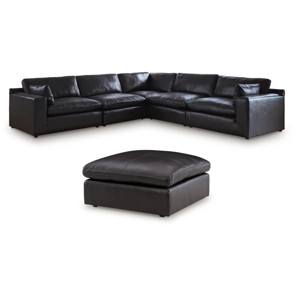 Black top-grain leather sectional sofa with chaise and matching ottoman