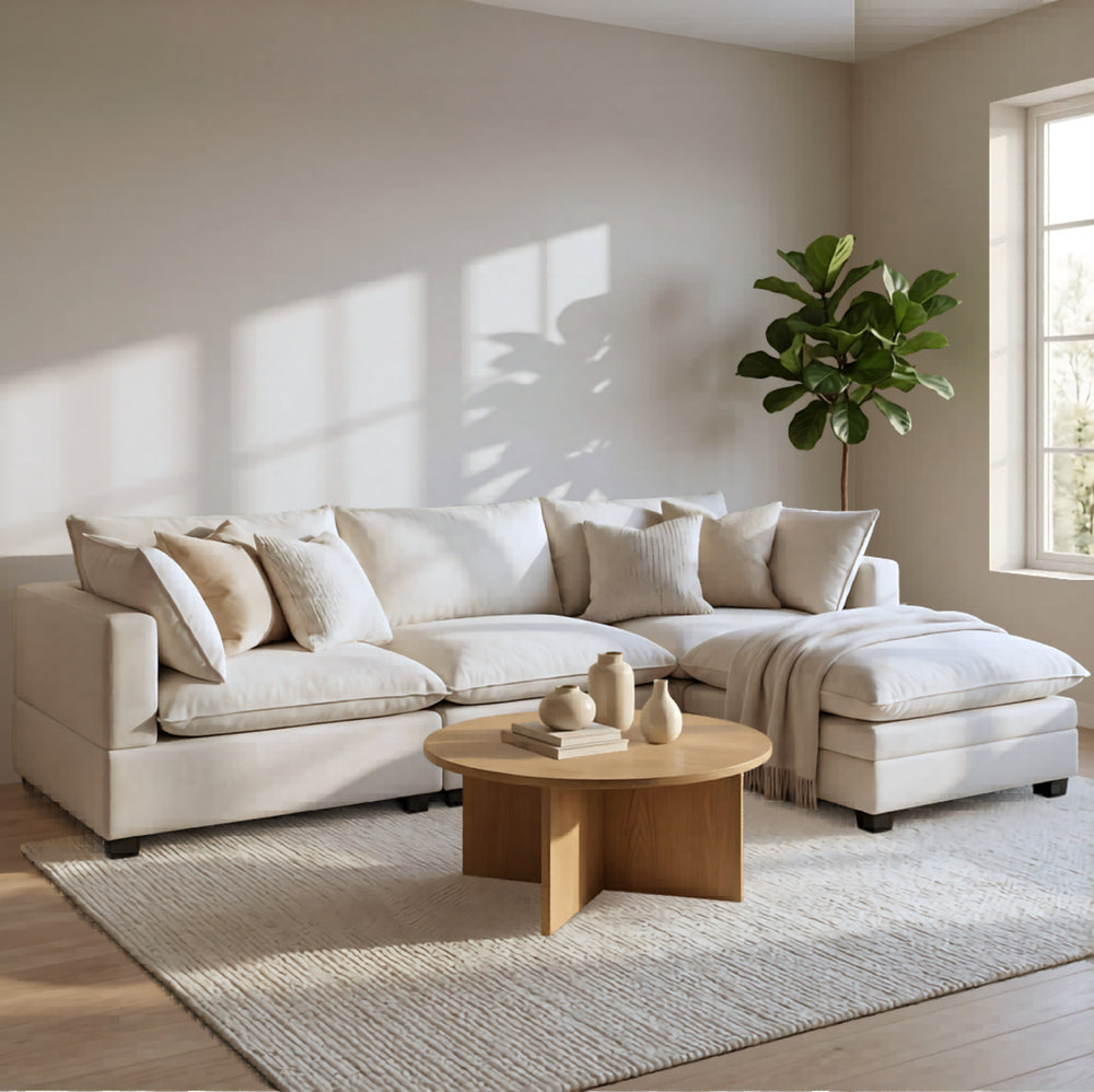 Light beige modular cloud sectional sofa with chaise and decorative throw pillows