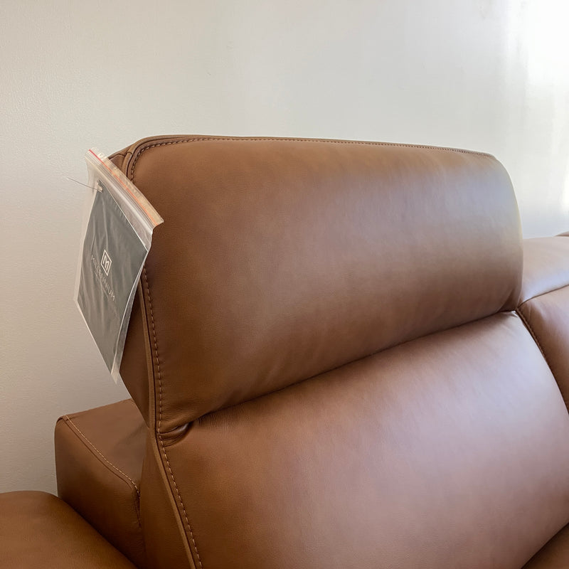 Caramel leather power recliner with stitched paneling and a side control area
