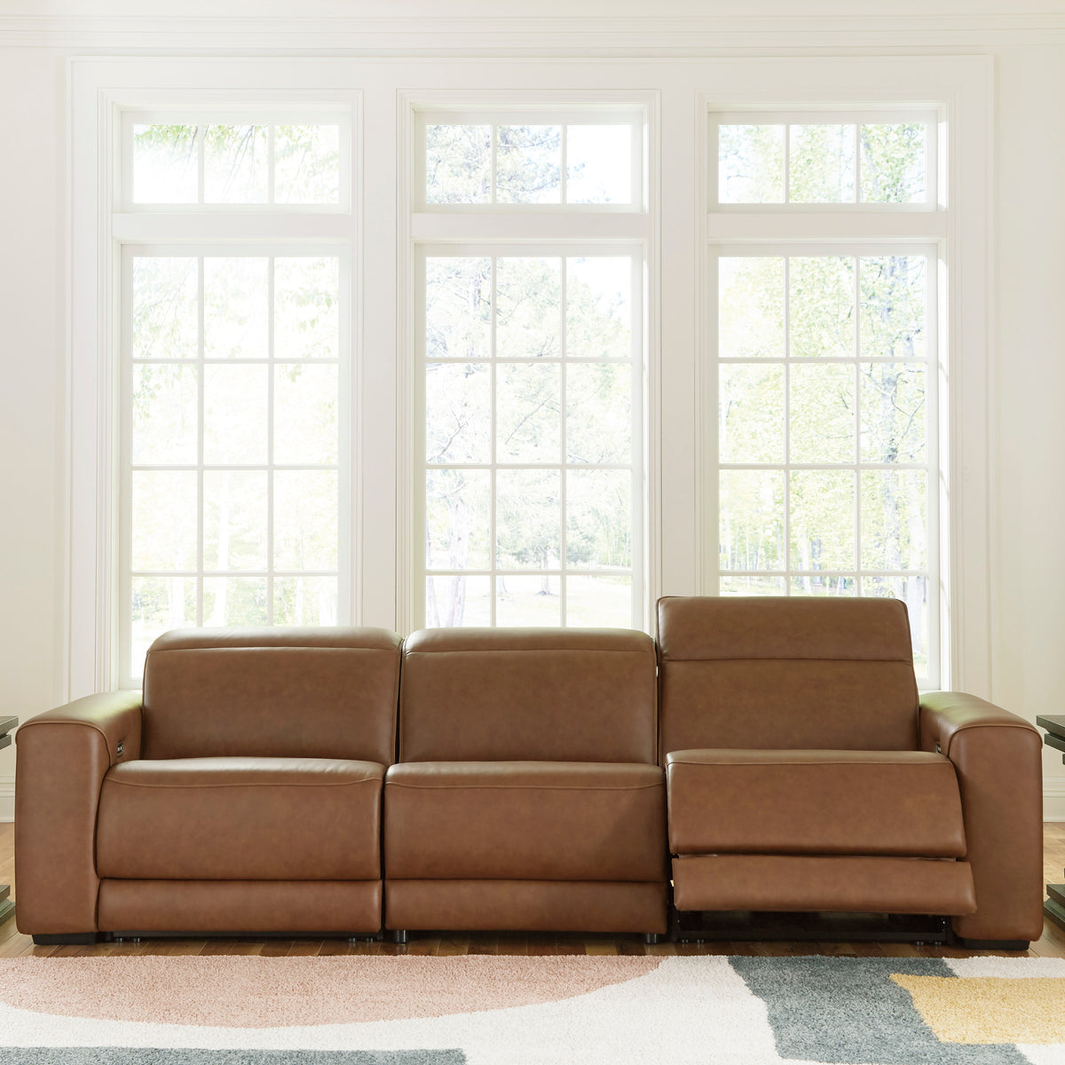 Caramel leather power reclining sectional with three seat sections and upright headrests