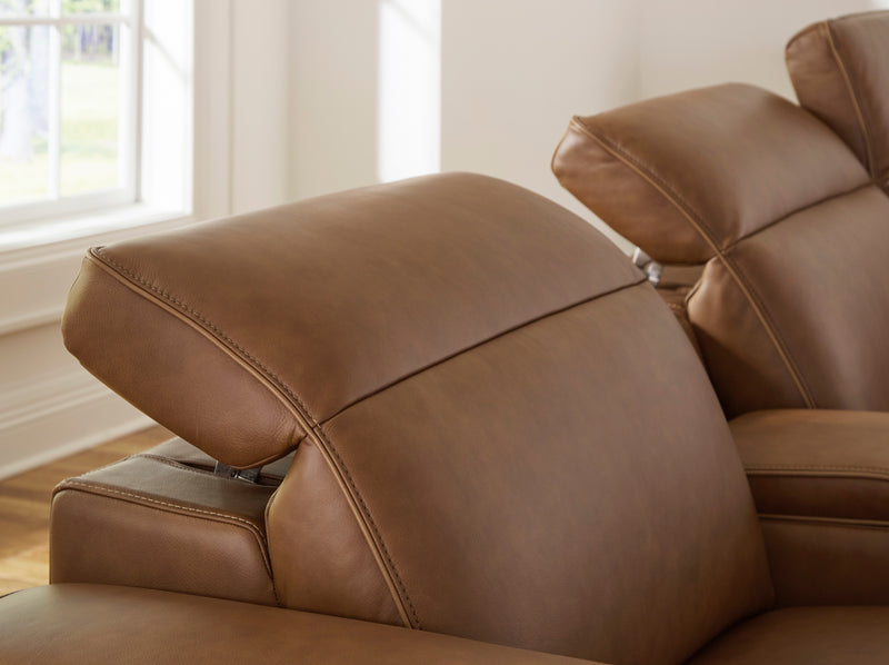 Caramel leather power recliner with padded headrest and reclined backrest