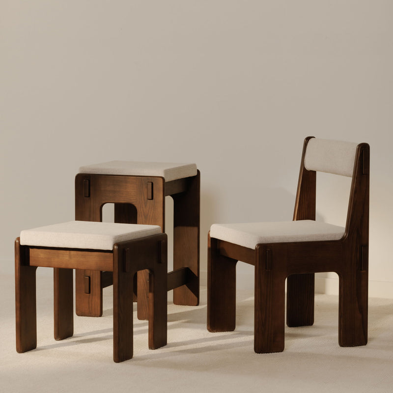 Set of counter stools with light beige cushions and dark brown wood frames, backless