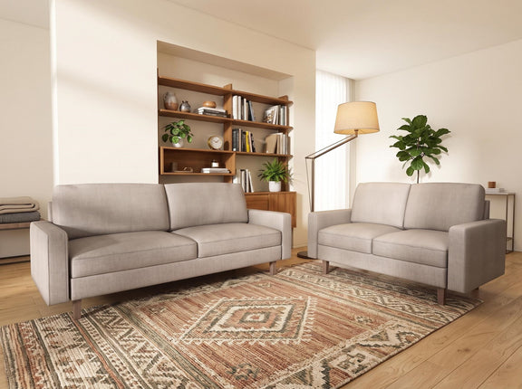 Light beige upholstered three-seat sofa with removable cushions and tapered wood legs