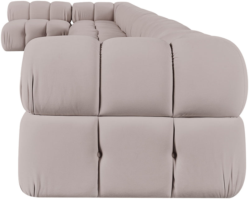 Light beige velvet L-shaped sectional sofa with tufted cushions and rounded arms.