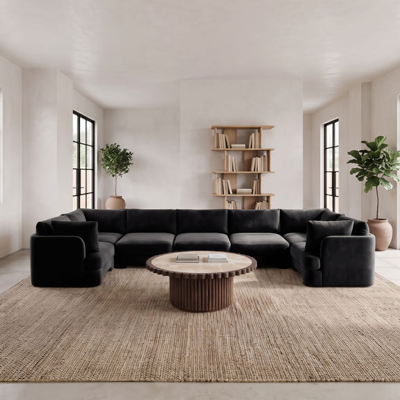 Black U-shaped sectional sofa with deep seats, rounded arms, and back cushions