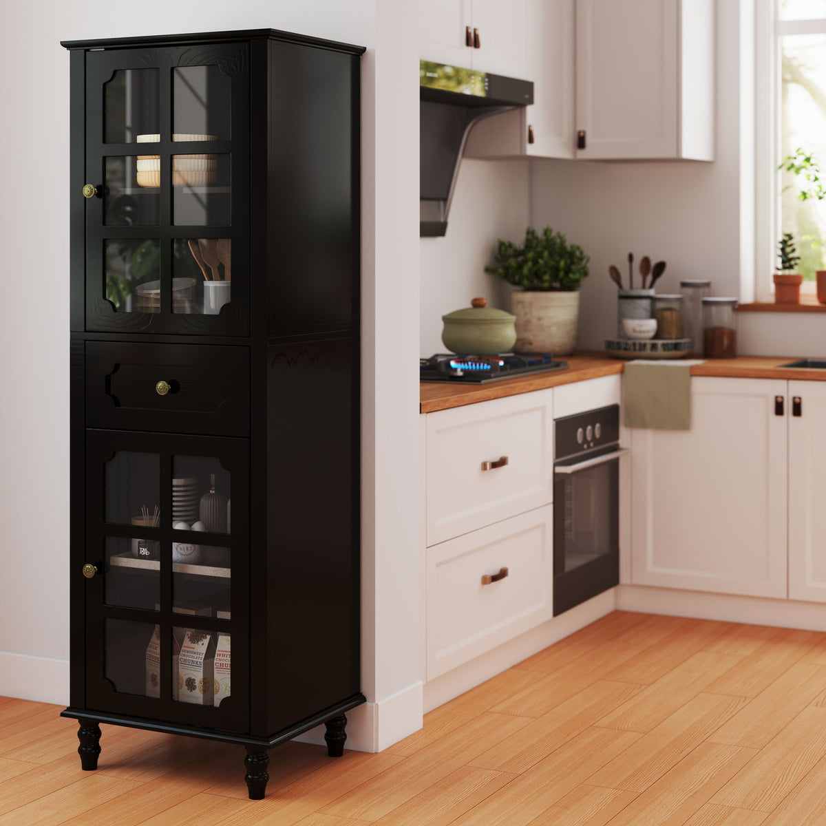 Black curio cabinet with glass grid doors and center drawer, shown stocked beside kitchen cabinets