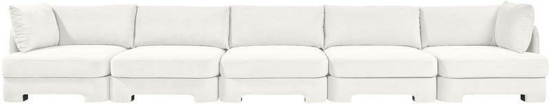 White velvet upholstered sectional sofa with modular seats and back cushions