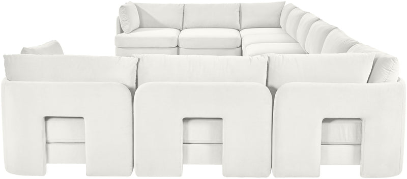 White velvet sectional sofa with modular seating and rounded arm panels