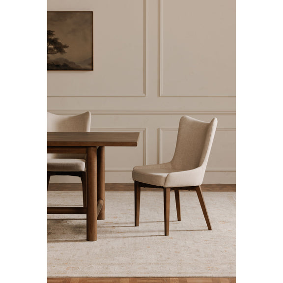 Dining chair with a high curved back, beige upholstery, and dark wood legs
