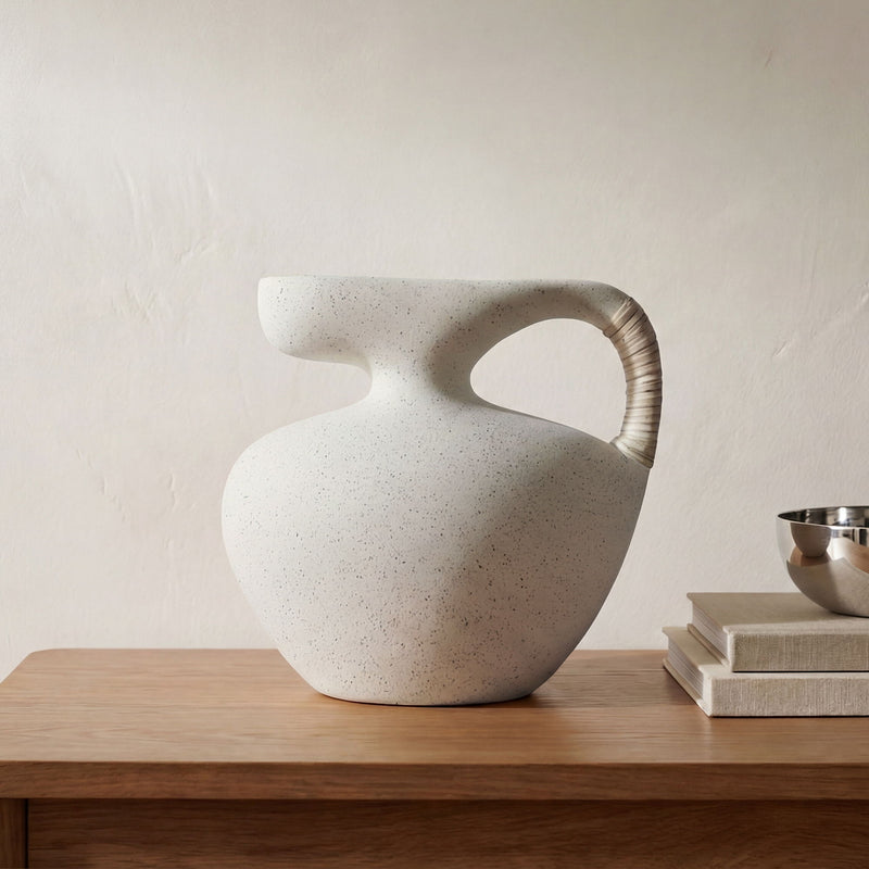 Cream sculptural ceramic vessel with ribbed handle and speckled finish