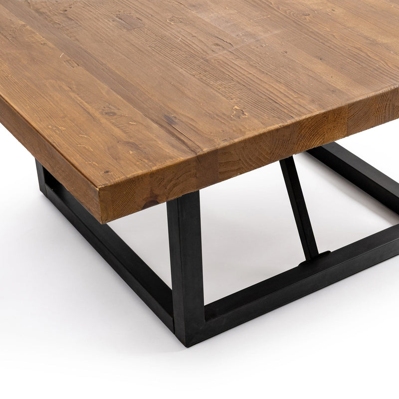Brown wood tabletop closeup with visible grain and black metal base edge