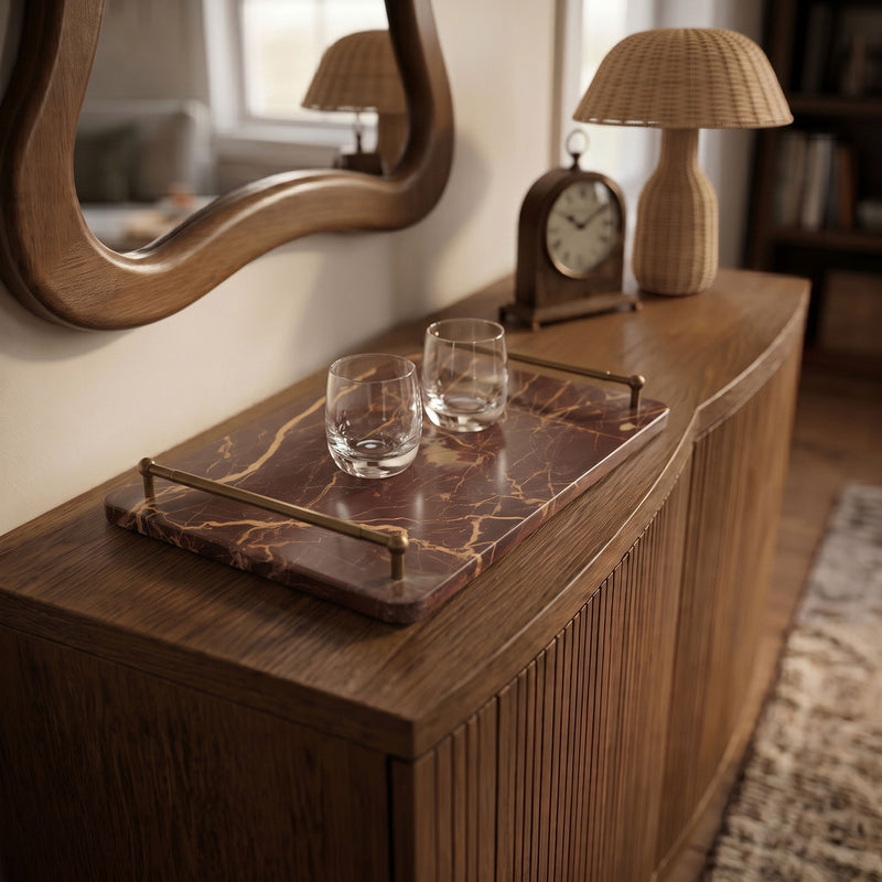 Dark red marble serving tray with brass corner handles and clear glass stem cups.