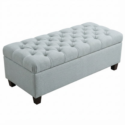 Light blue fabric storage ottoman bench with tufted top and hinged lid