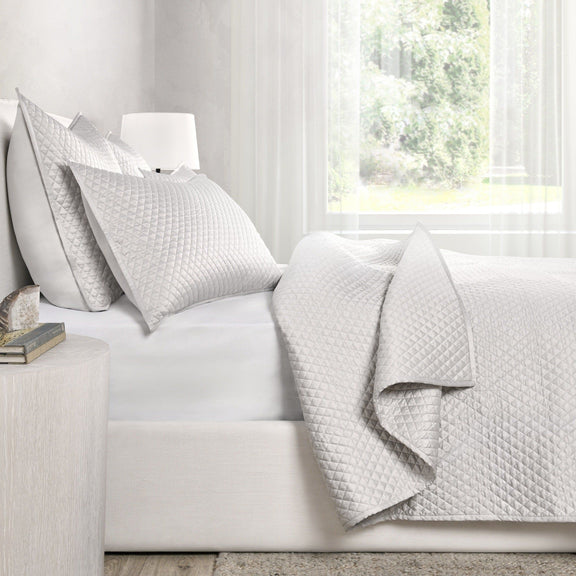Quilted rectangular sham pillows in light gray, diamond pattern texture