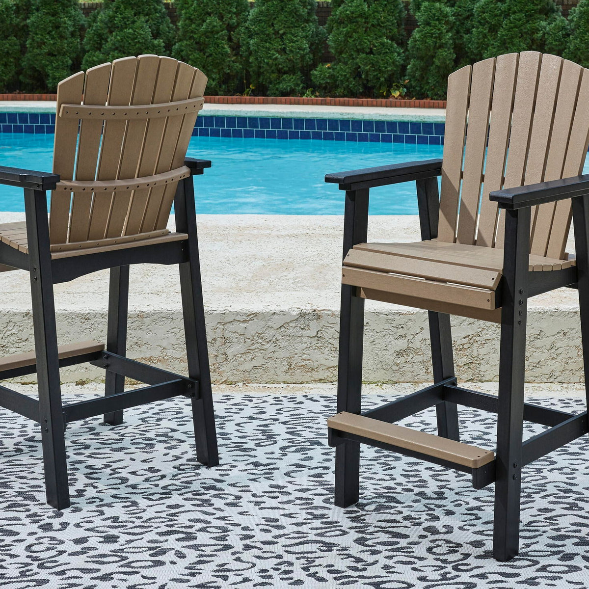 Outdoor tall barstool set with dark frame, driftwood slat backs, and cushioned seats