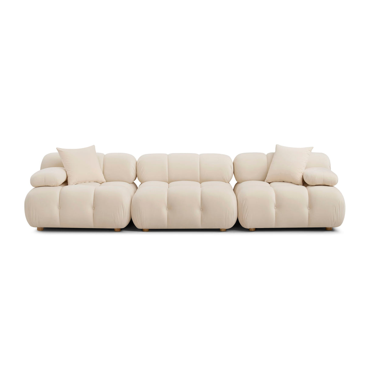 Light cream modular sofa with padded arms, tufted sections, and square base