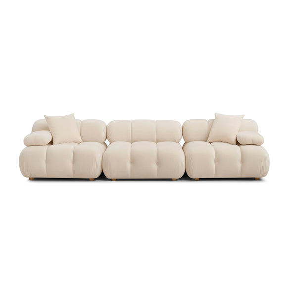Light cream modular sofa with padded arms, tufted sections, and square base