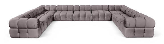 Light gray velvet upholstered sectional sofa with tufted seat and rounded armrests