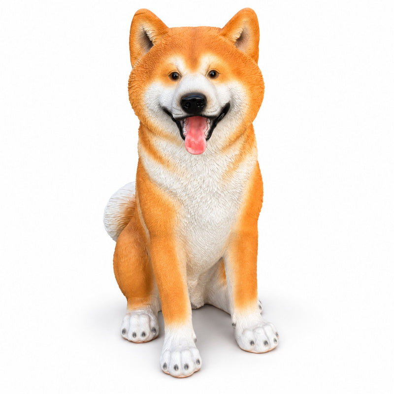 Sitting Shiba Inu dog statue with orange and white fur, curled tail, and open mouth