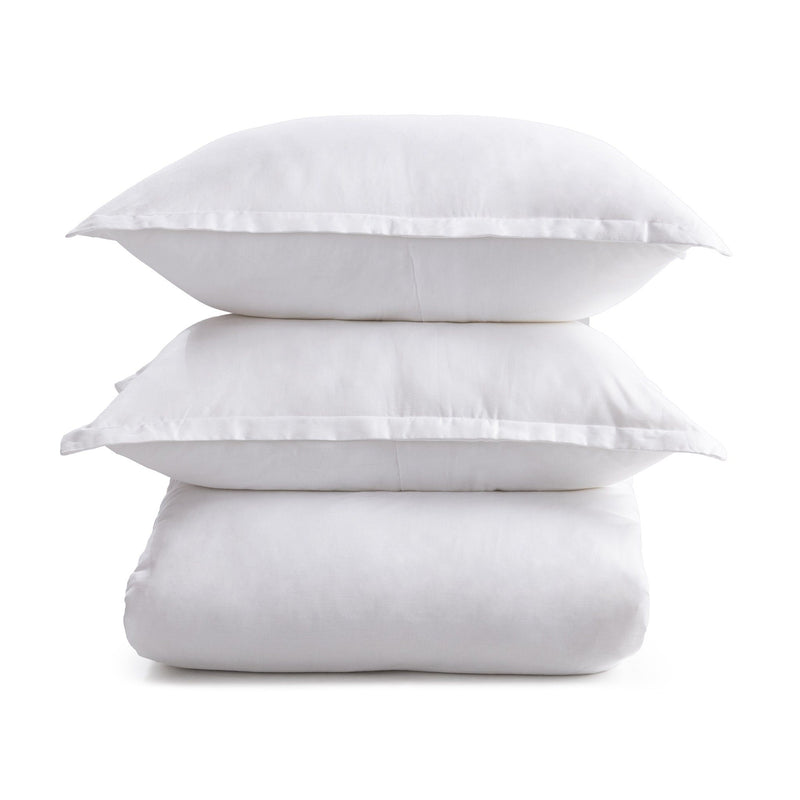 White pillow shams stacked, smooth fabric with stitched border