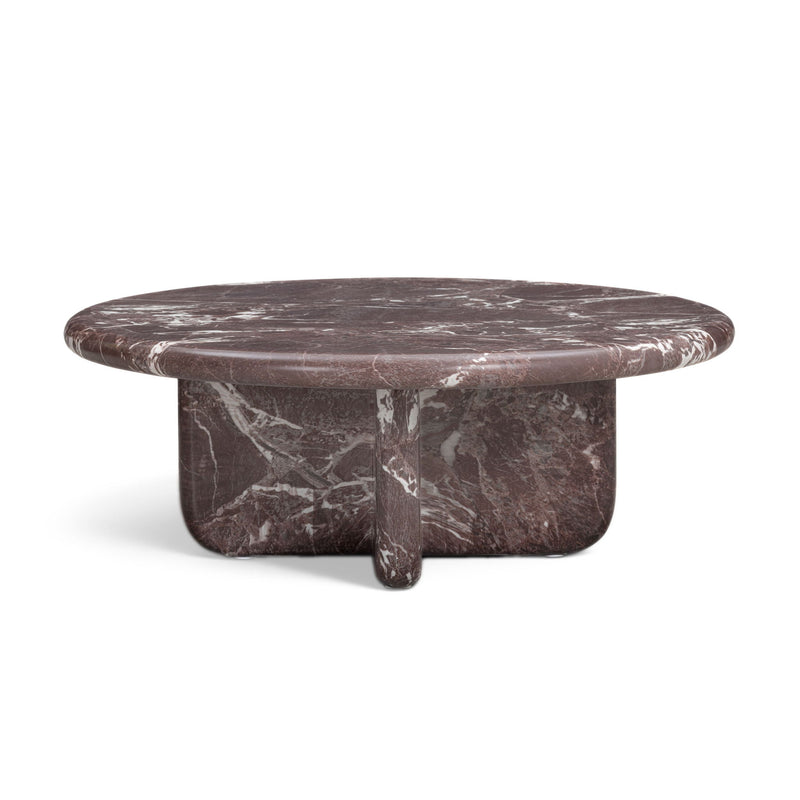 Round dark red coffee table with white veined top and short pedestal support