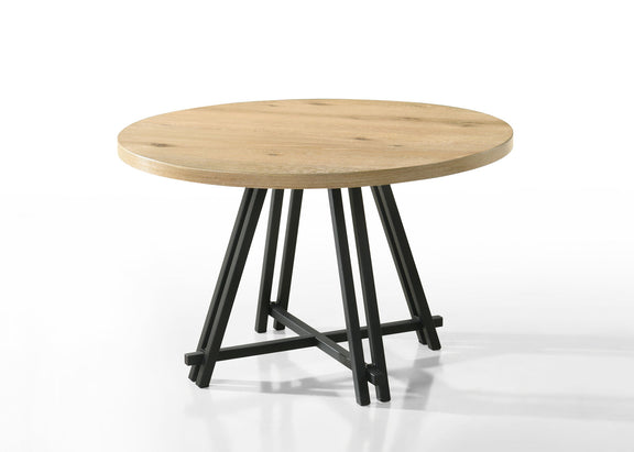 Round oak dining table with black cross-legged base and light wood grain top