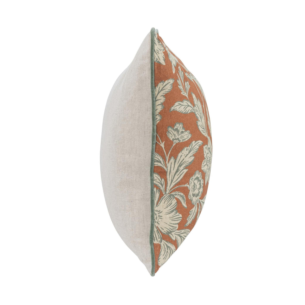 Rust floral accent pillow with solid light backing shown from the side