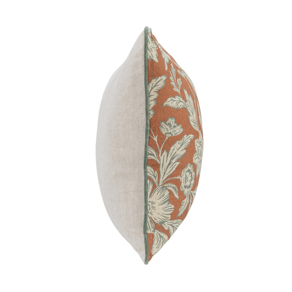 Rust floral accent pillow with solid light backing shown from the side