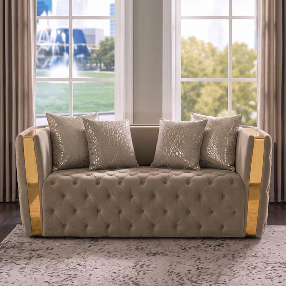 Taupe button-tufted loveseat with gold-finished arms and patterned throw pillows