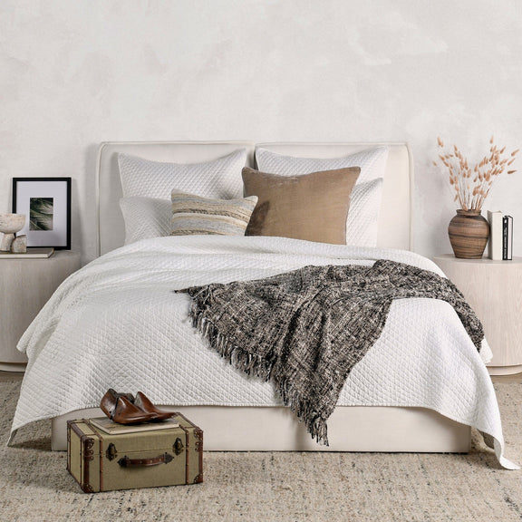 Quilted rectangular sham pillows in white with diamond pattern and piped edges