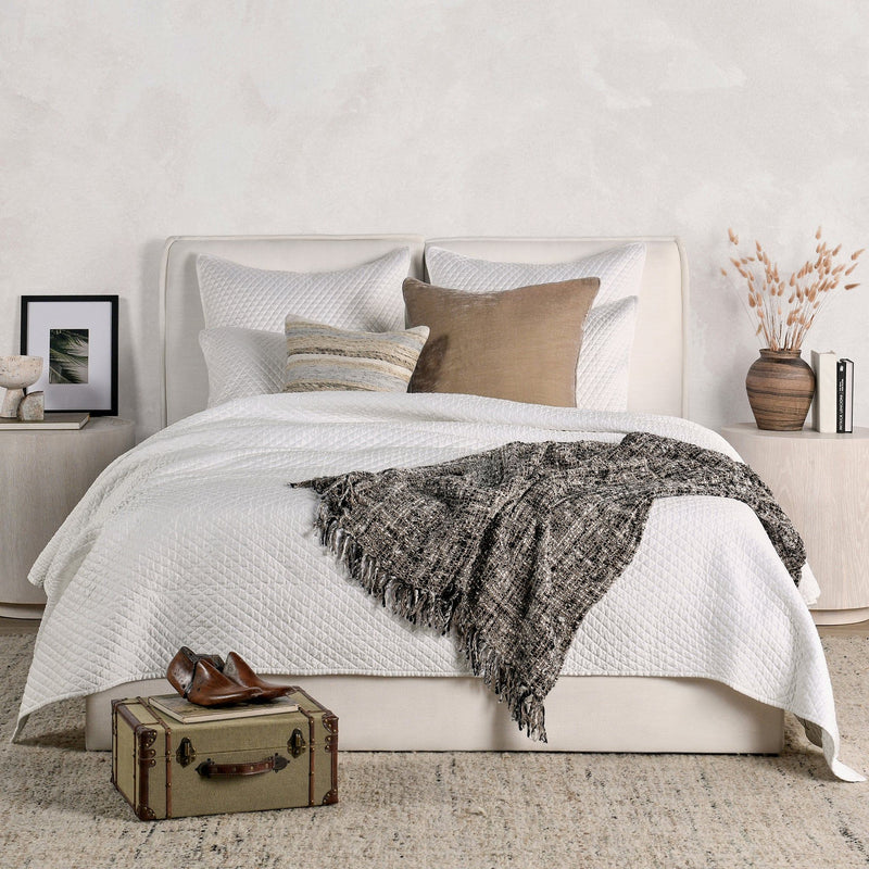 Quilted rectangular sham pillows in white with diamond pattern and piped edges