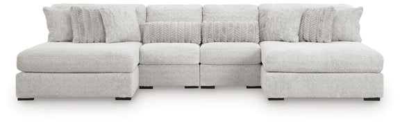 White sectional sofa with two ottomans and multiple cushion sections