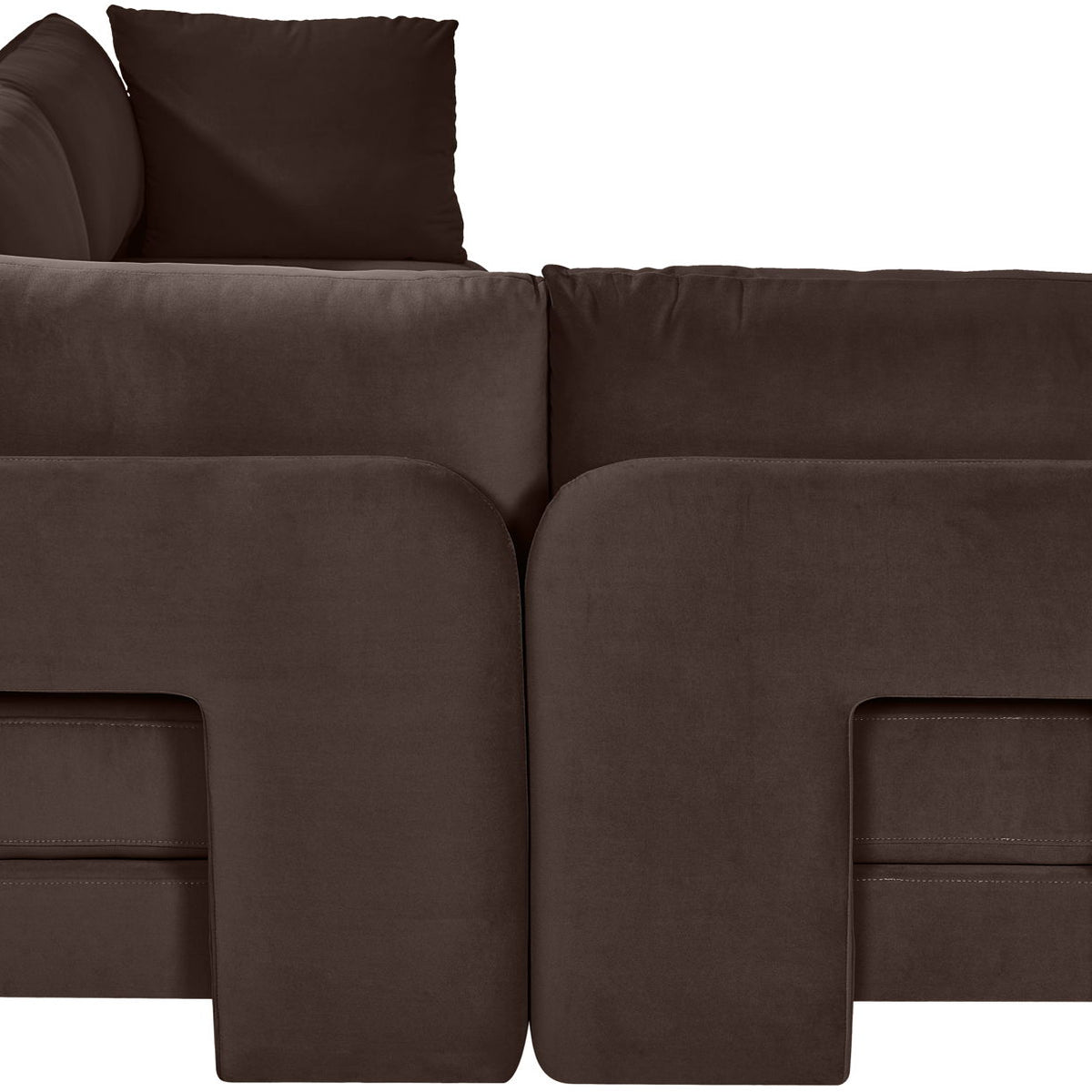 Dark brown velvet armless sectional sofa, close-up of rounded arm and cushion