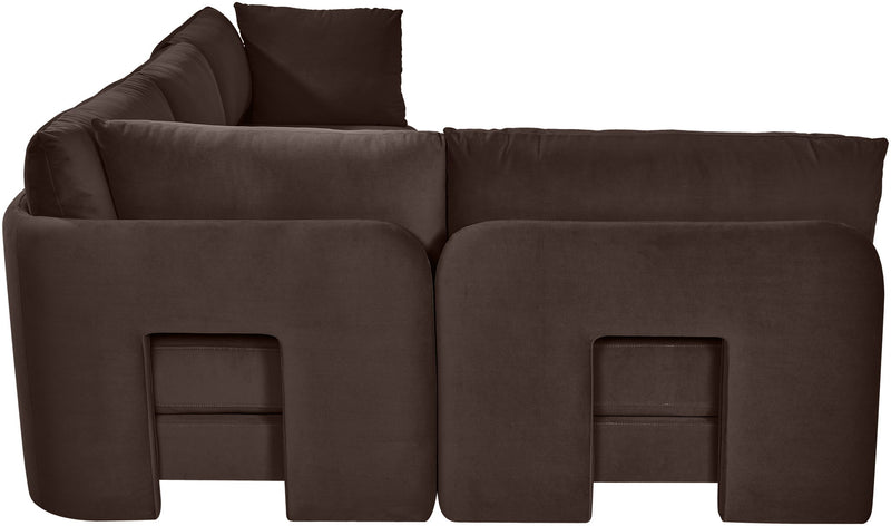 Dark brown velvet armless sectional sofa, close-up of rounded arm and cushion