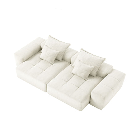 Beige oversized sectional sofa with padded back cushions, four throw pillows, and two ottoman blocks