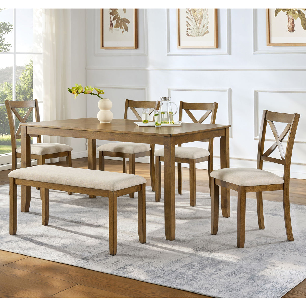 Dining table set with upholstered bench and four cross-back chairs around rectangular table.