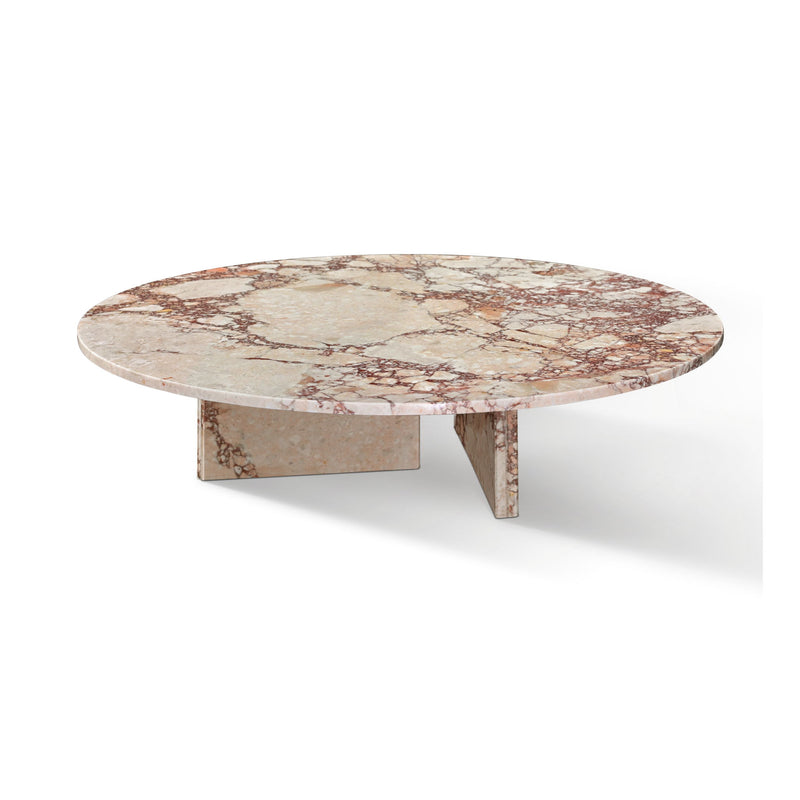 Round stone coffee table with beige top and pinkish veining on angular base supports
