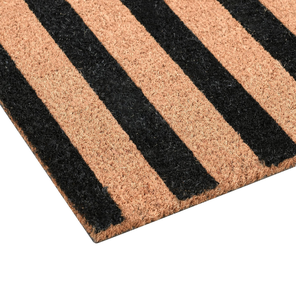 Close-up of black and tan striped doormat with rough textured fiber surface