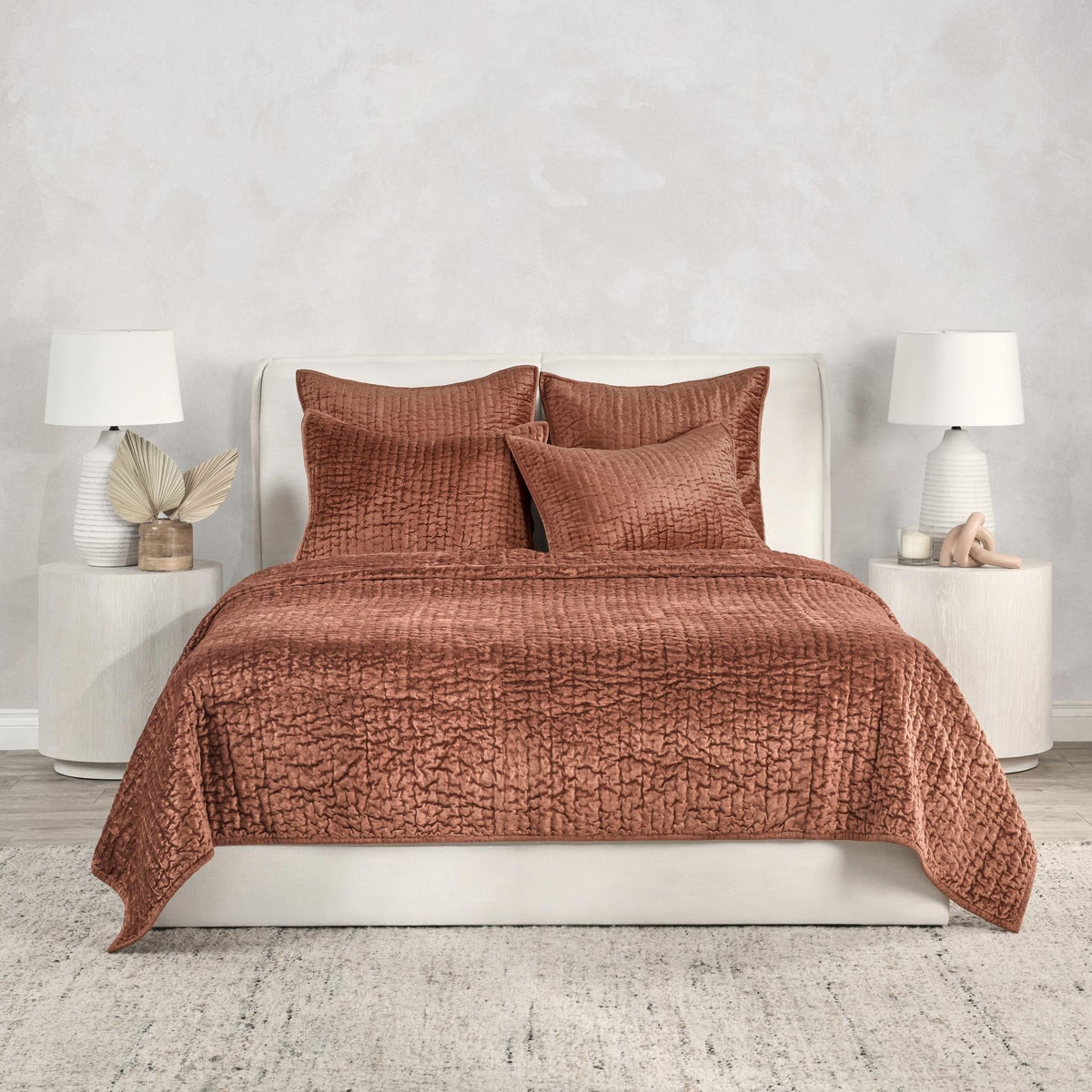 Terracotta velvet quilt set with matching shams and decorative pillows
