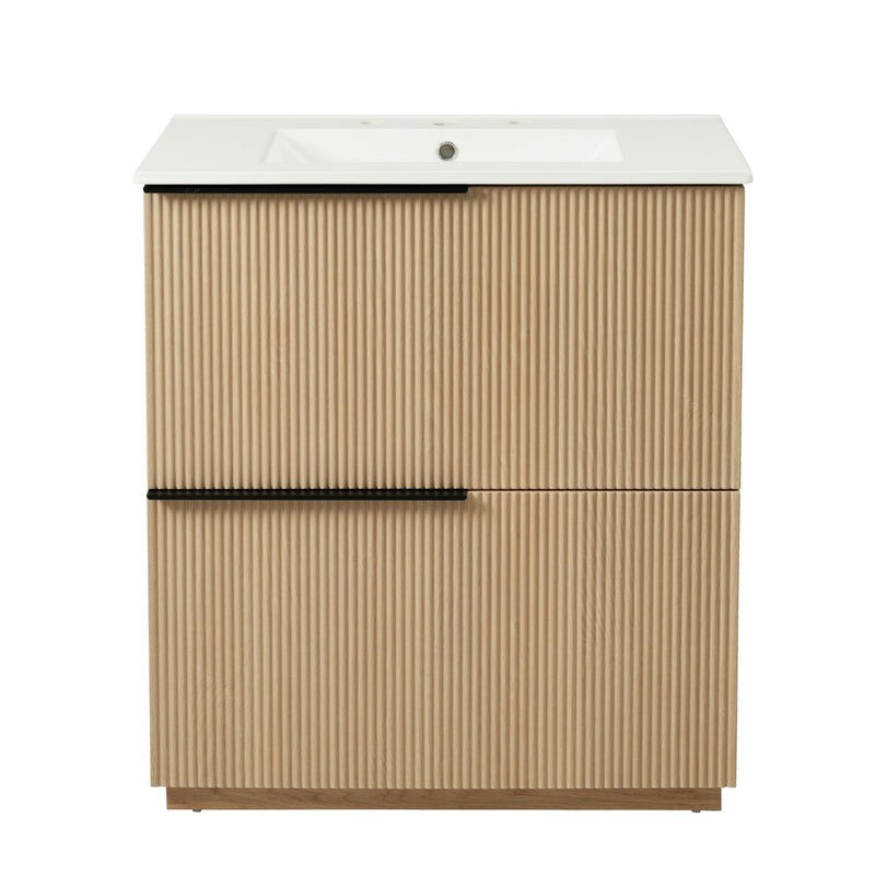 Light brown fluted bathroom vanity with white ceramic sink and center handle bar
