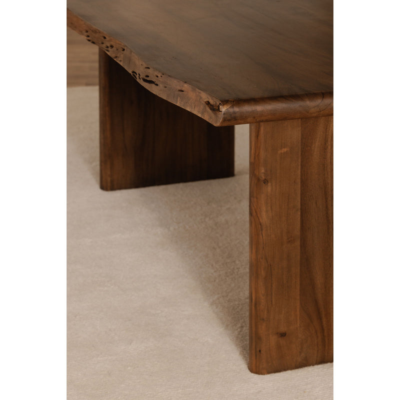 Small dining table corner detail: brown wooden legs and live-edge tabletop