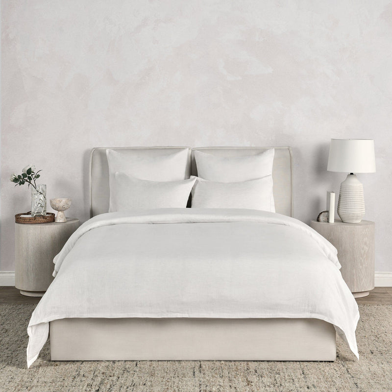 Linen-cashmere shams in white on a bed, rectangular with knife-edge seams