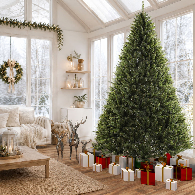 Dark green artificial Christmas tree with dense branch tips on a metal base