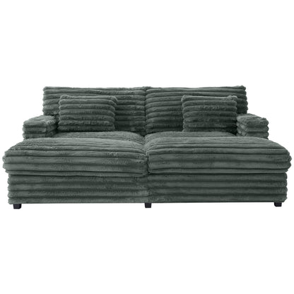 Oversized double chaise lounge sofa in dark green with ribbed plush upholstery and three cushions