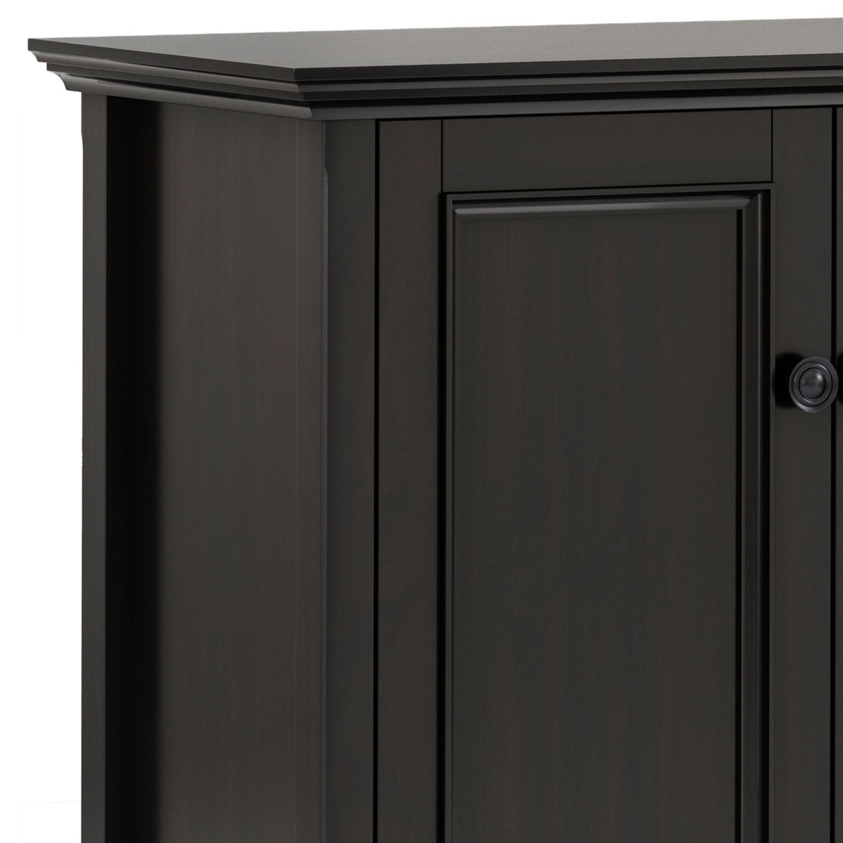 Close-up of the cabinet's dark brown finish, raised door panel, and round knob