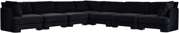 Black velvet corner sectional sofa with tufted cushions and low profile arms