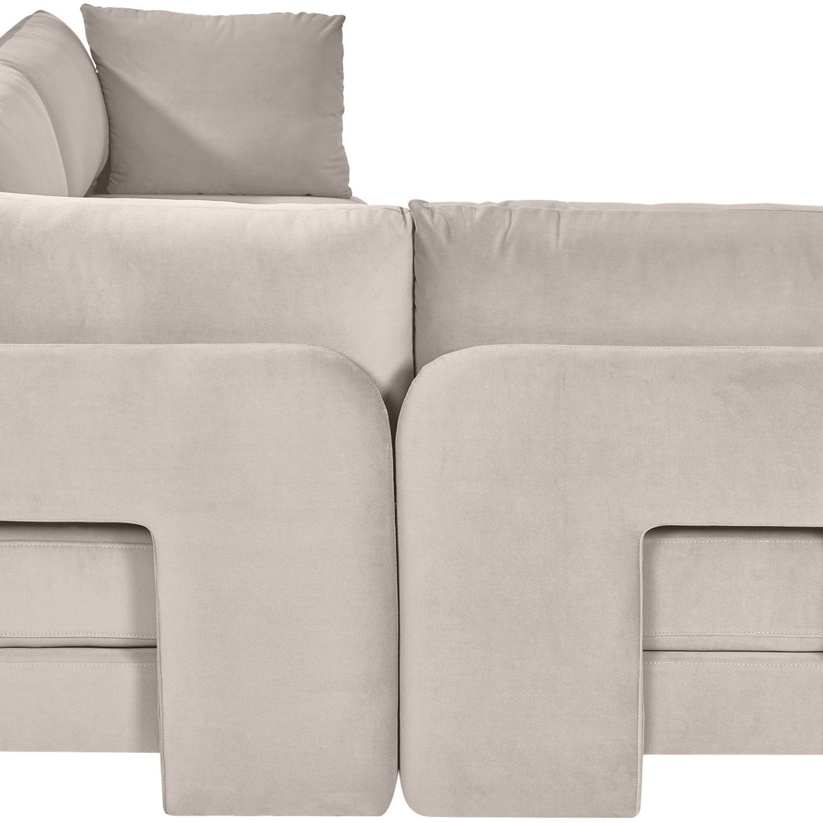 Light gray velvet armless sectional sofa, close-up of rounded arm panels