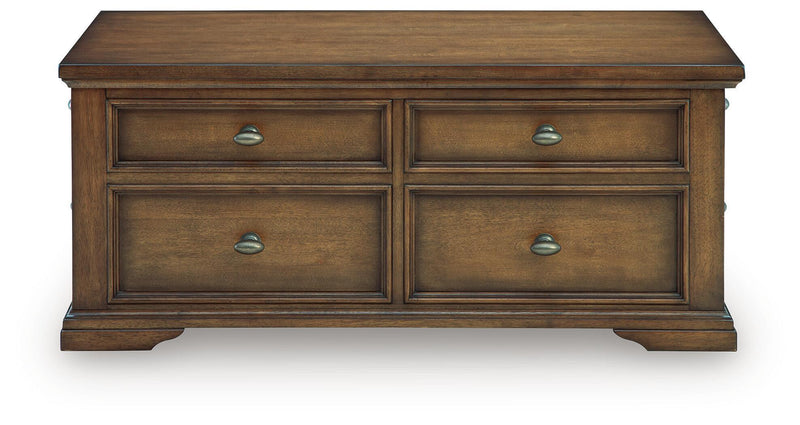 Dark brown wood coffee table front with four drawers and metal cup pulls, flat top