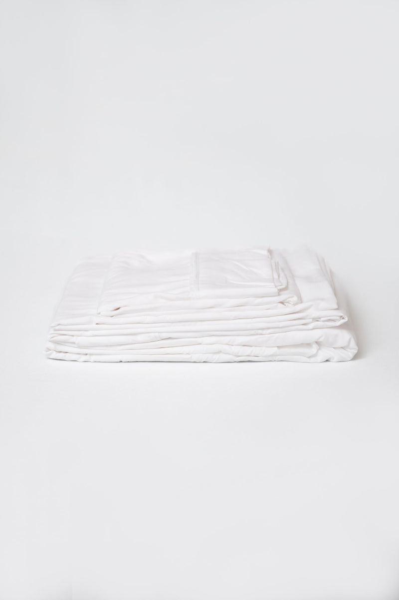 White brushed split sheet set, neatly folded stack of sheets